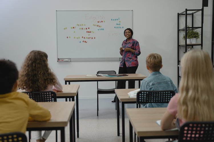 Photo by Tima Miroshnichenko: https://www.pexels.com/photo/teacher-smiling-at-her-students-5427998/