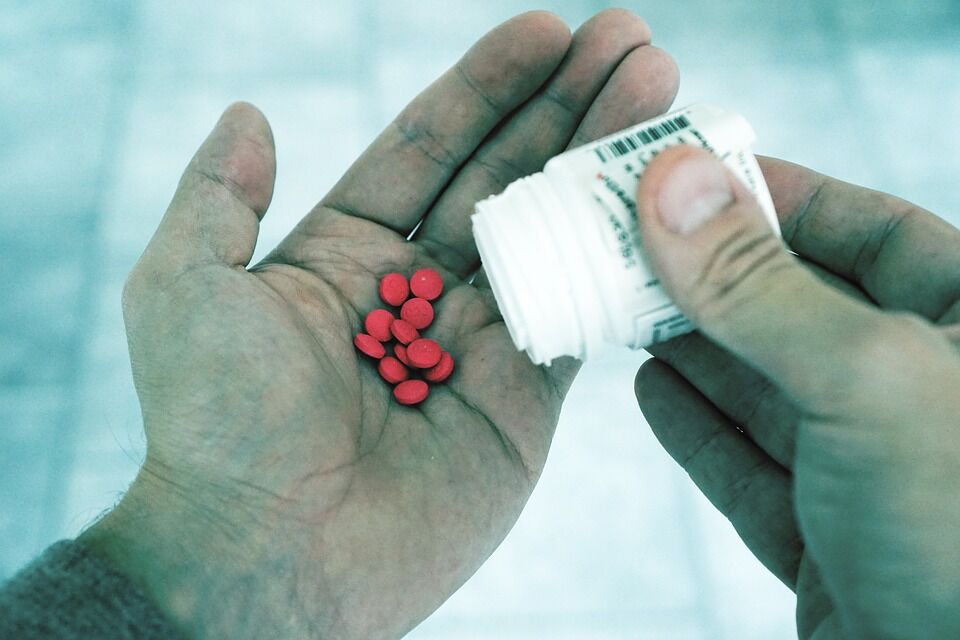 Person spilling pills into their hands