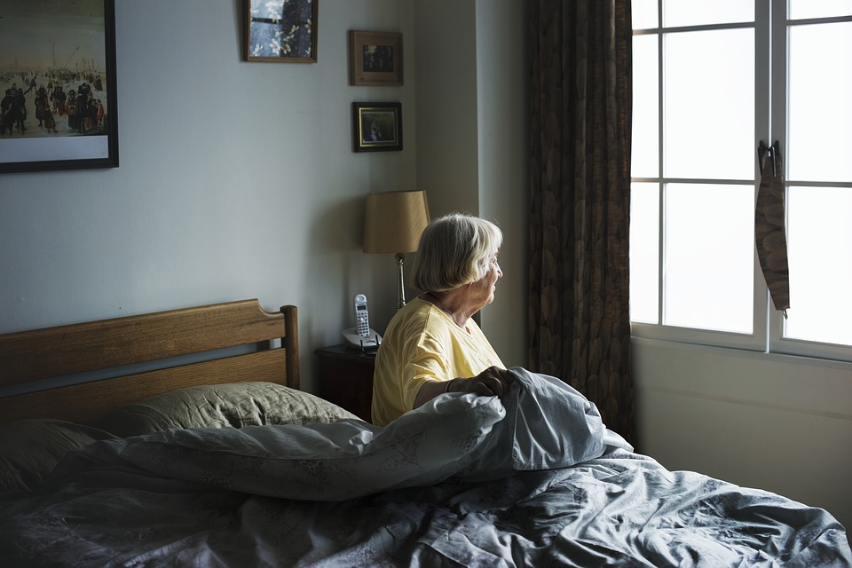 Older woman getting out of bed
