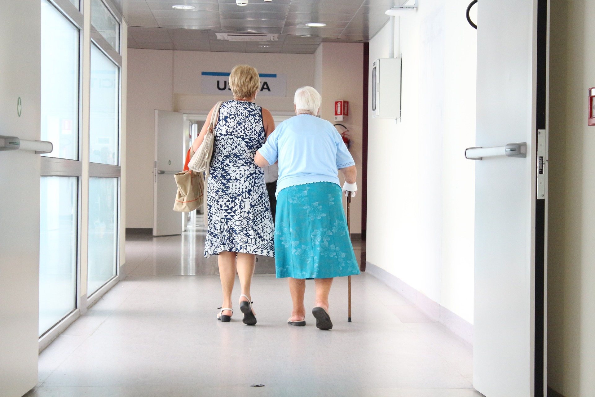 Patients walking down hospital hallway Image by sarcifilippo from Pixabay 