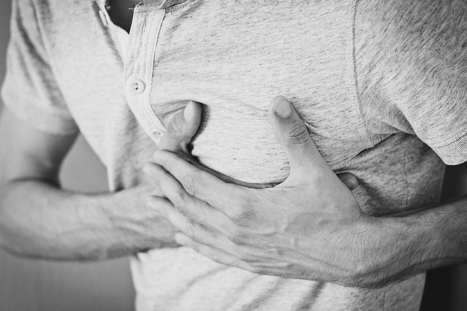 Man clutching chest with heart pain