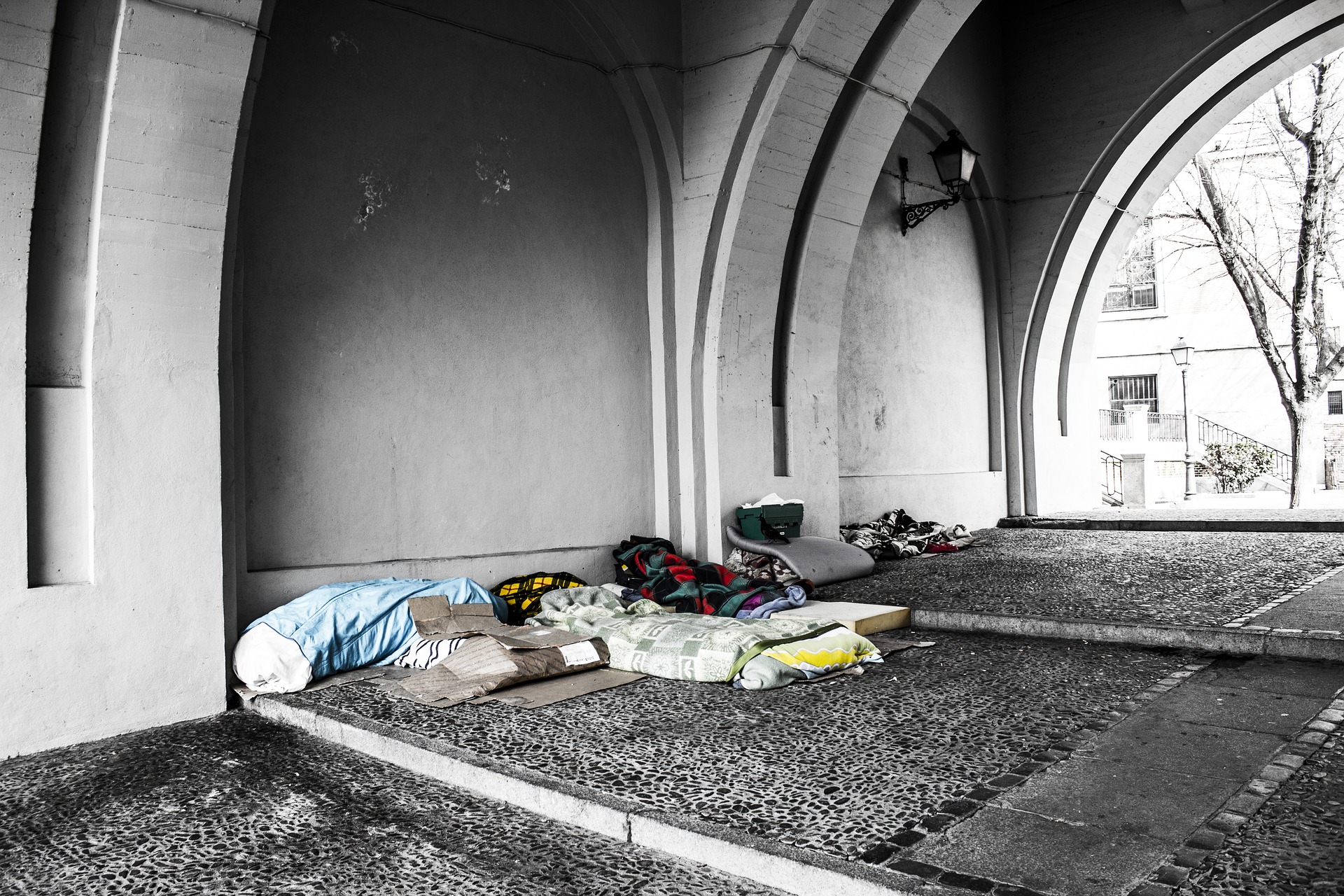 Mattresses and blankets under overpass