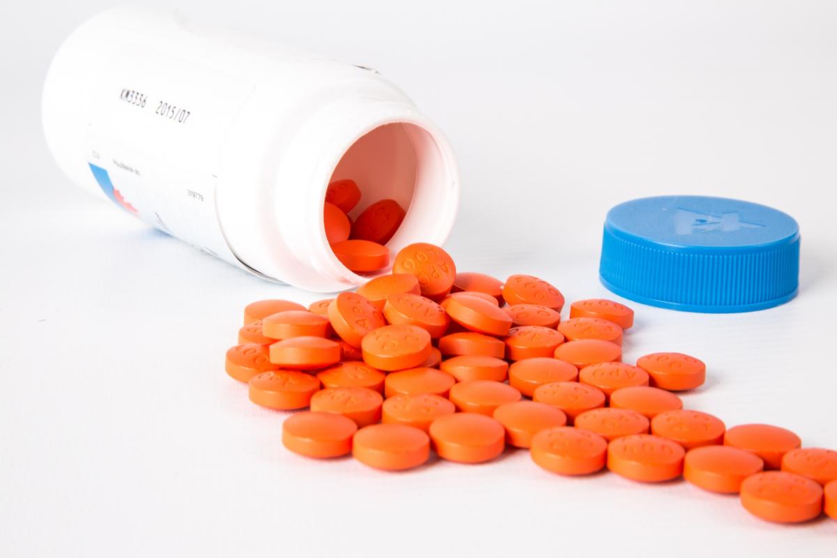 Spilled medication bottle with orange tablets