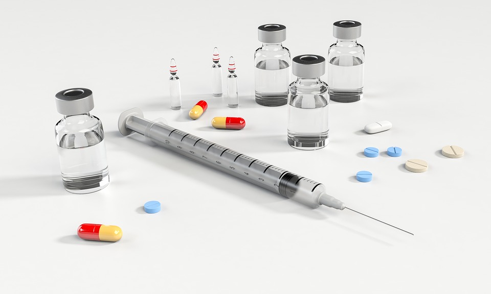 Syringe, pills, bottles, and capsules