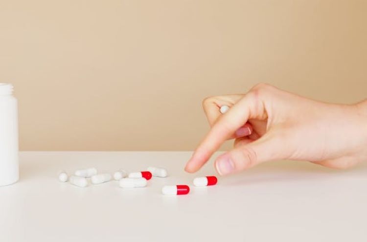 Photo by Artem Podrez: https://www.pexels.com/photo/crop-patient-taking-pill-from-table-4492103/