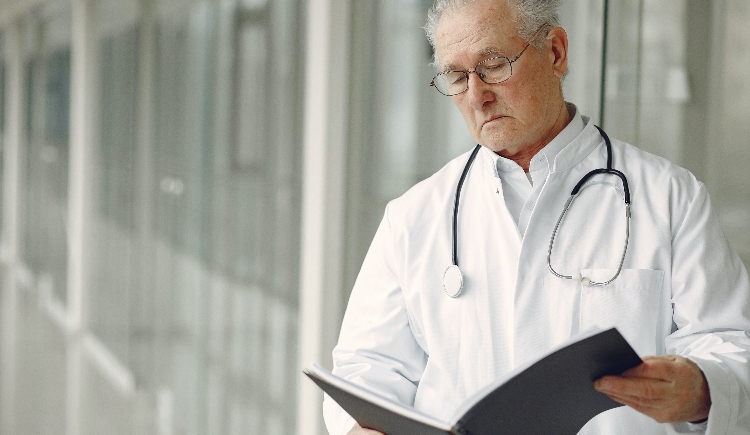Doctor looking at paperwork Photo by Gustavo Fring from Pexels
