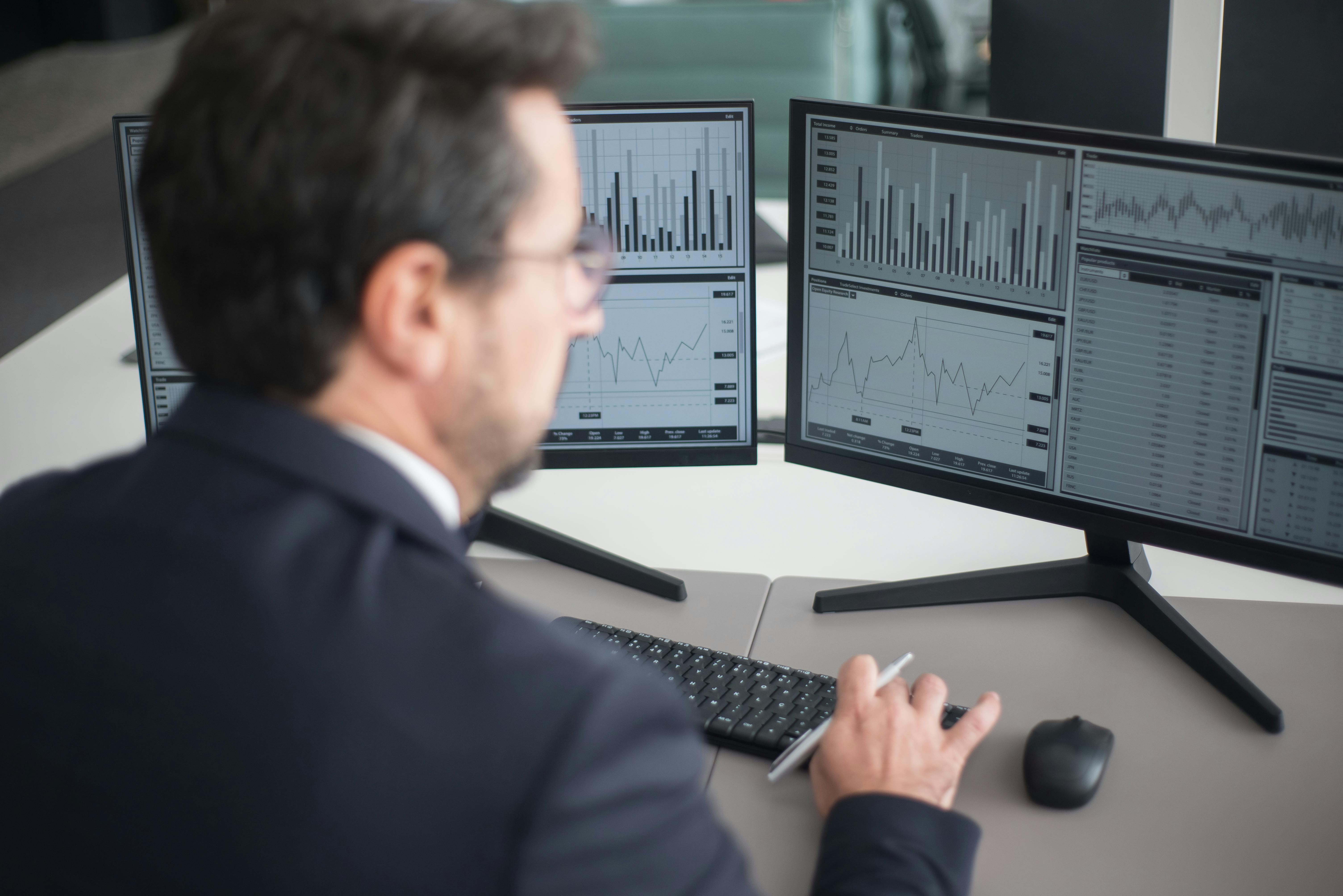 Man in Black Suit Jacket Using Computer
