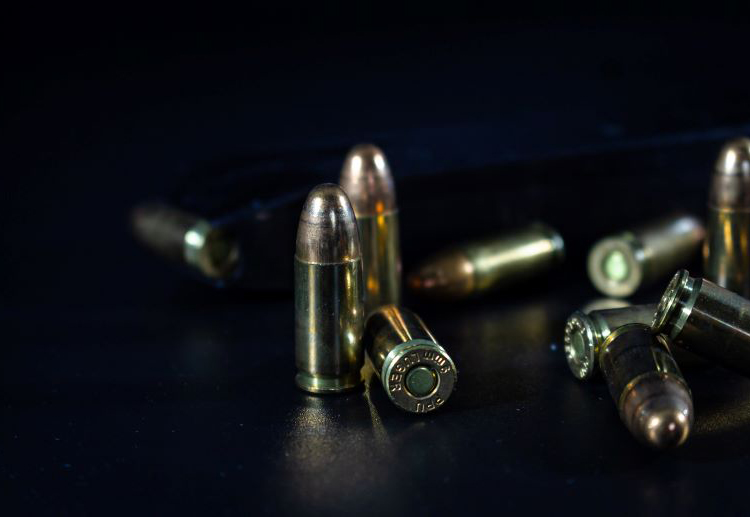photo of bullets on a table in the dark by Terrance Barksdale
