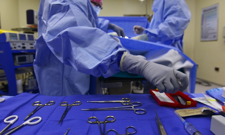 Surgeon reaching for tools