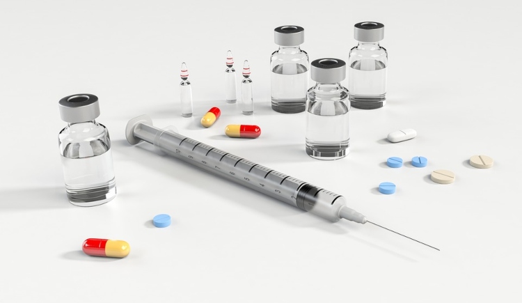 Syringe, pills, bottles, and capsules