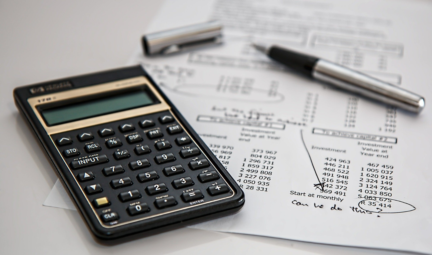 Calculator on top of paper with numbers and calculations Image by Steve Buissinne from Pixabay