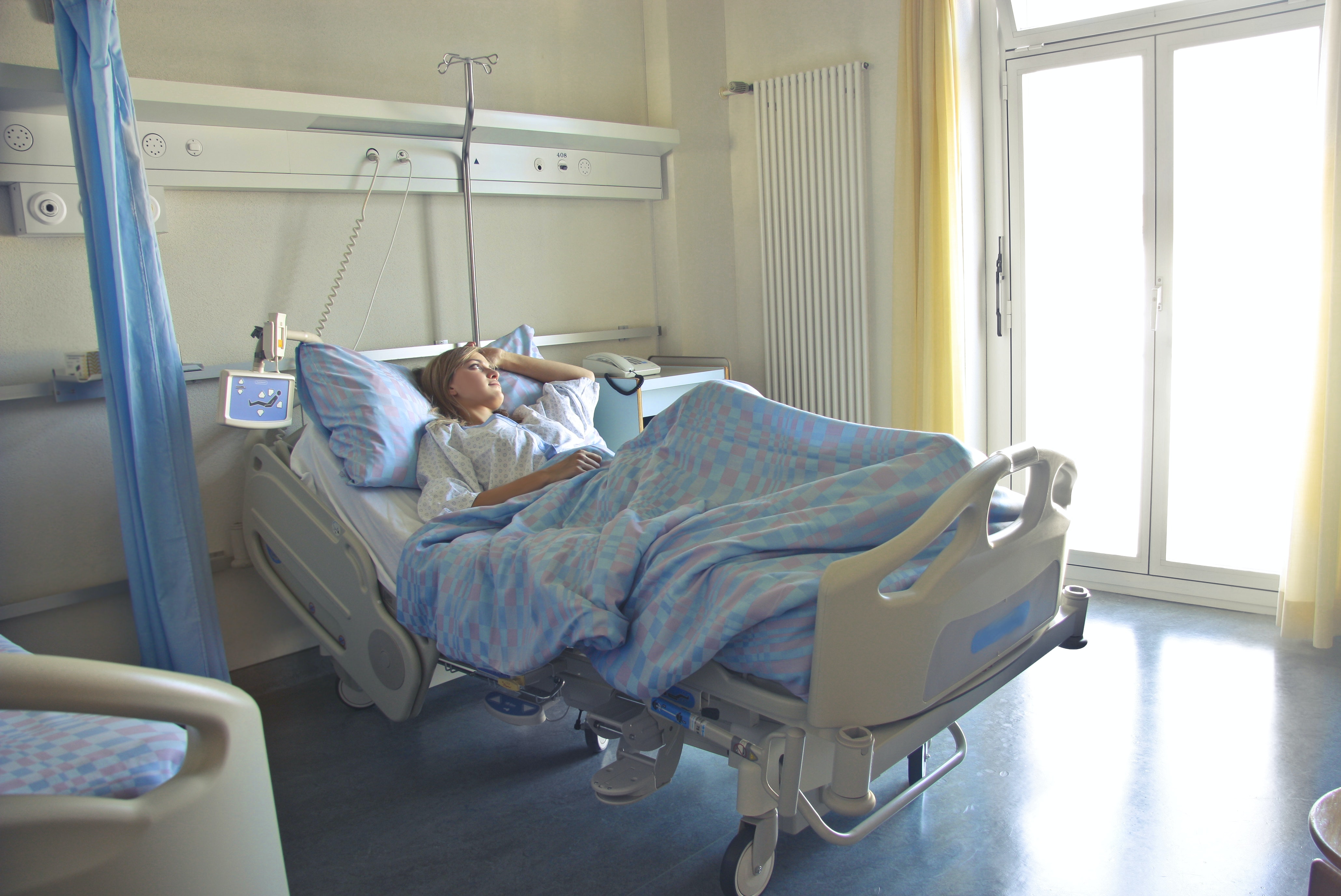 Woman lying in hospital bed Photo by Andrea Piacquadio from Pexels