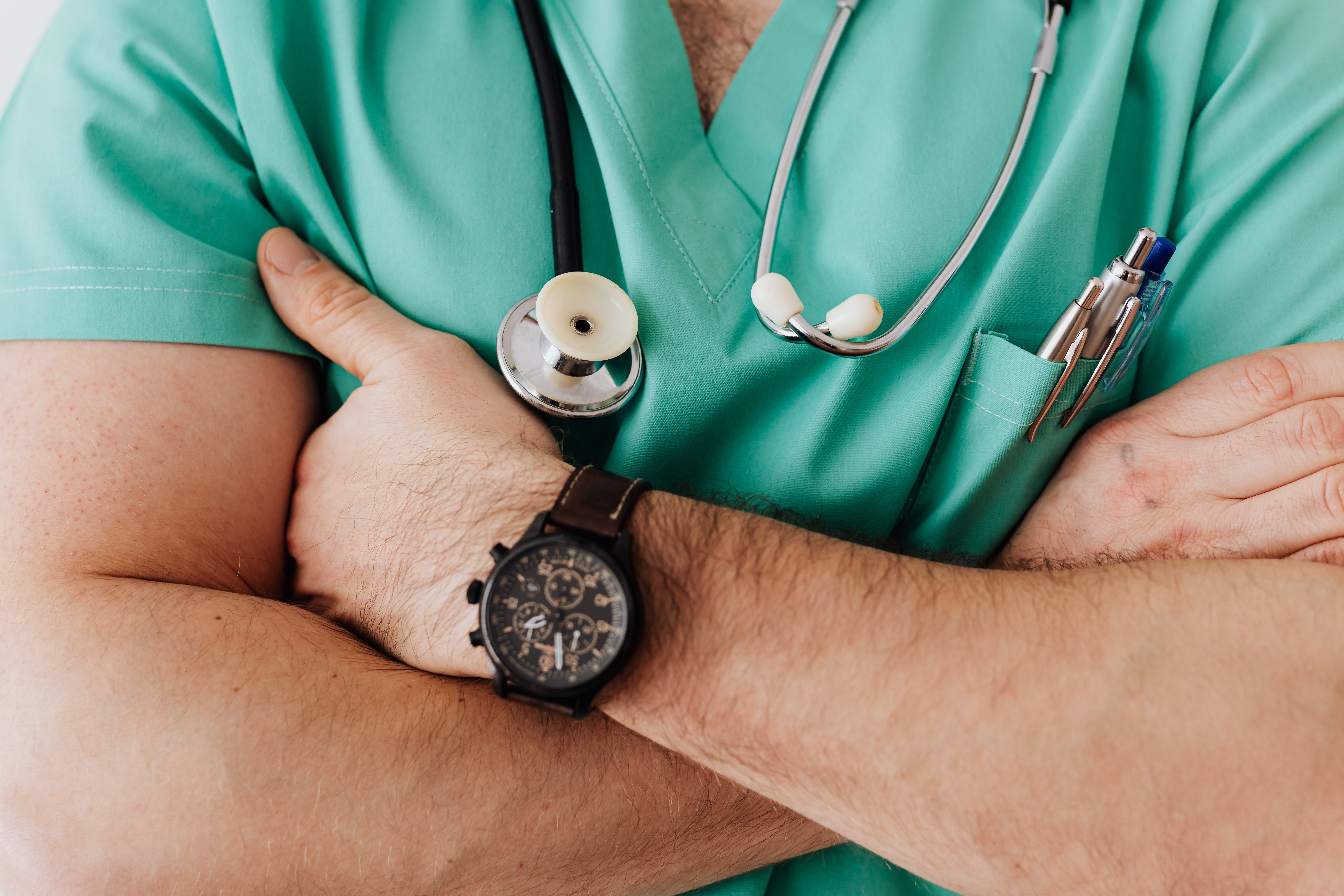 Close up photo of person in green scrubs with arms crossed Photo by Karolina Grabowska from Pexels