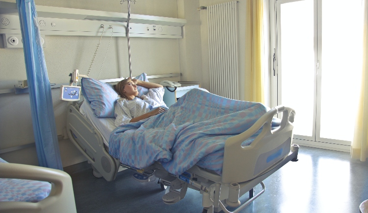 Woman lying in hospital bed Photo by Andrea Piacquadio from Pexels
